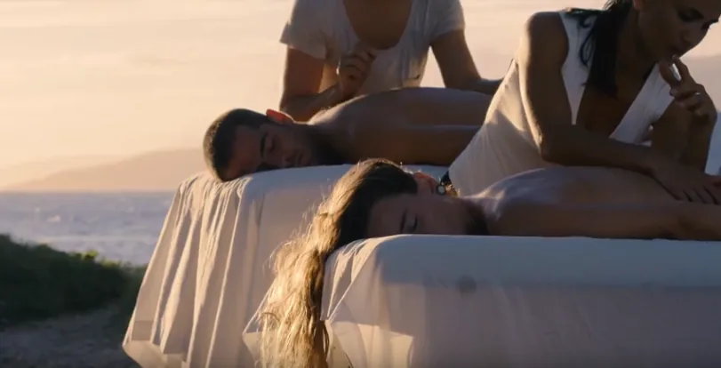 Massage table set up on a lush tropical lawn with panoramic ocean views