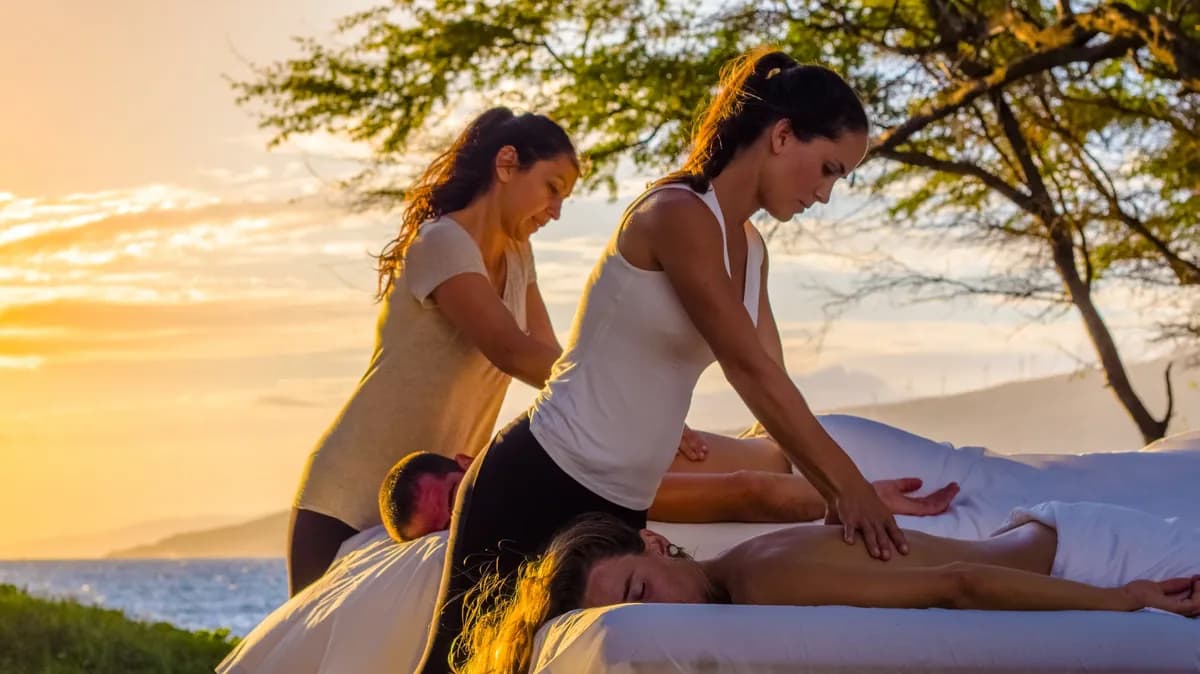 Couples massage at sunset overlooking the Maui coastline